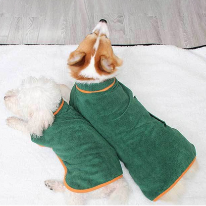 Two dogs wearing a Dog Bathrobe, a soft absorbent towel for pets, relaxing on a blanket.